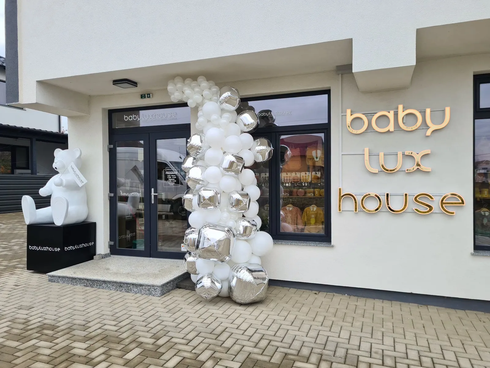 Coloana organica din baloane albe si argintii la un magazin Baby Lux House