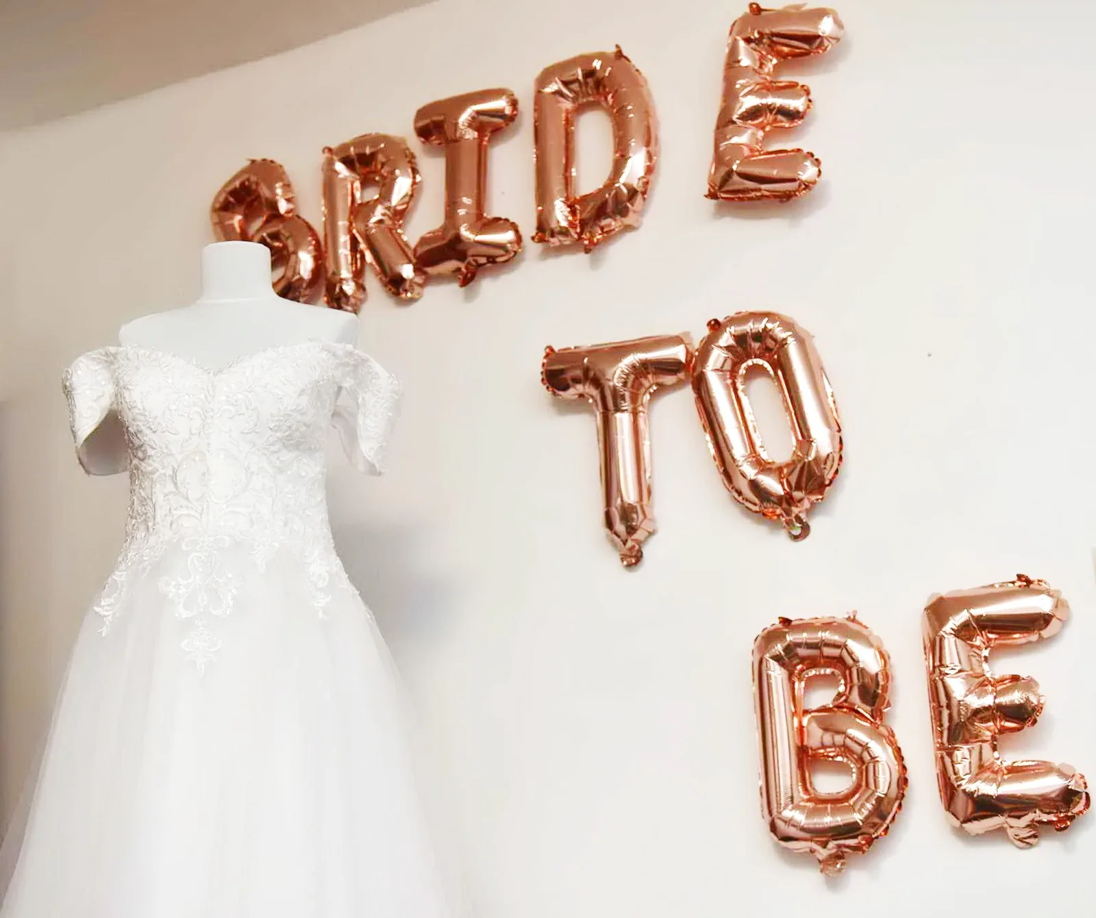 Manechin cu rochie de mireasă albă din dantelă și baloane aurii „BRIDE TO BE”